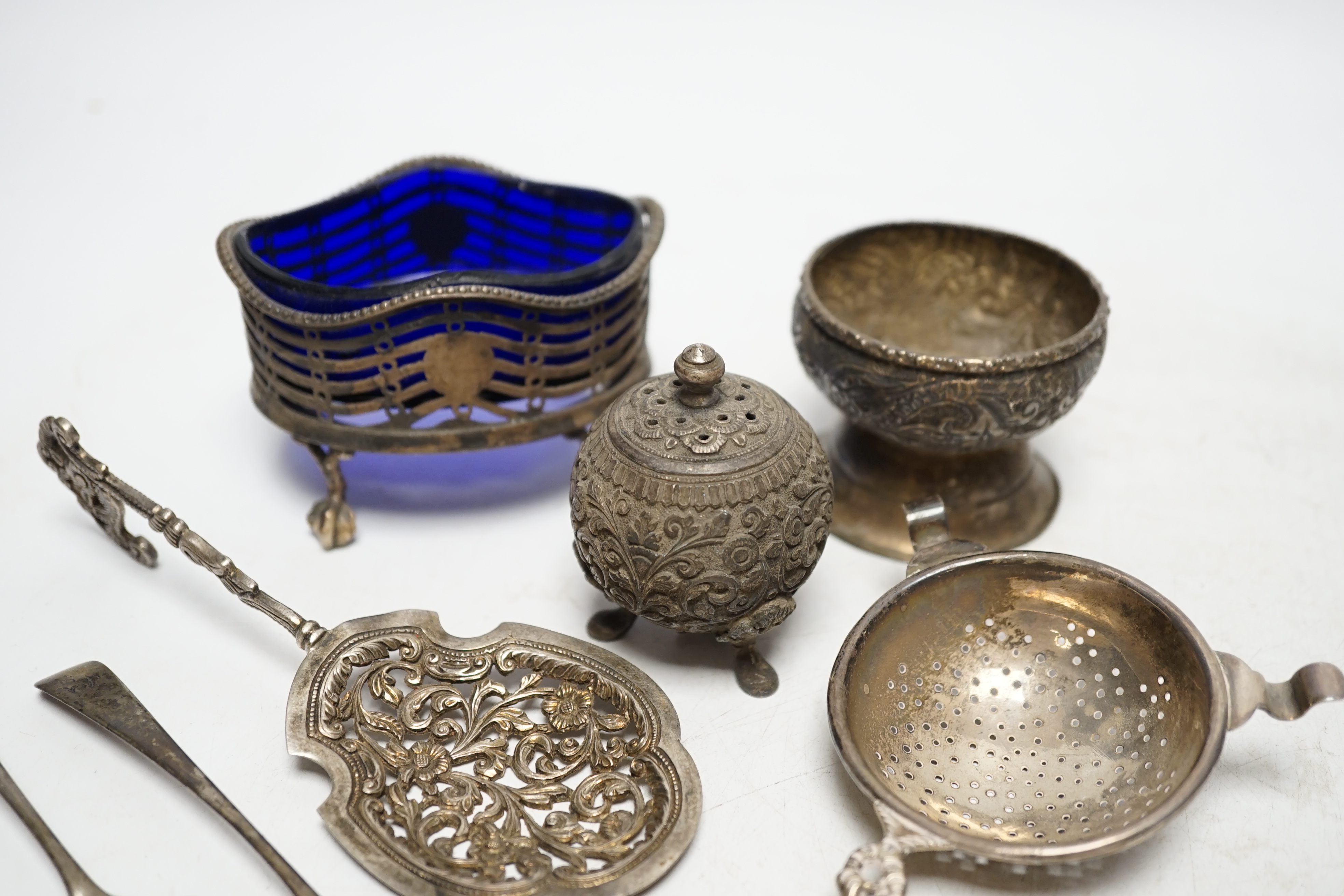 A group of small silver and white metal items including a George III oval salt, two Georgian condiment spoons, Indian condiment, etc. Condition- Fair.